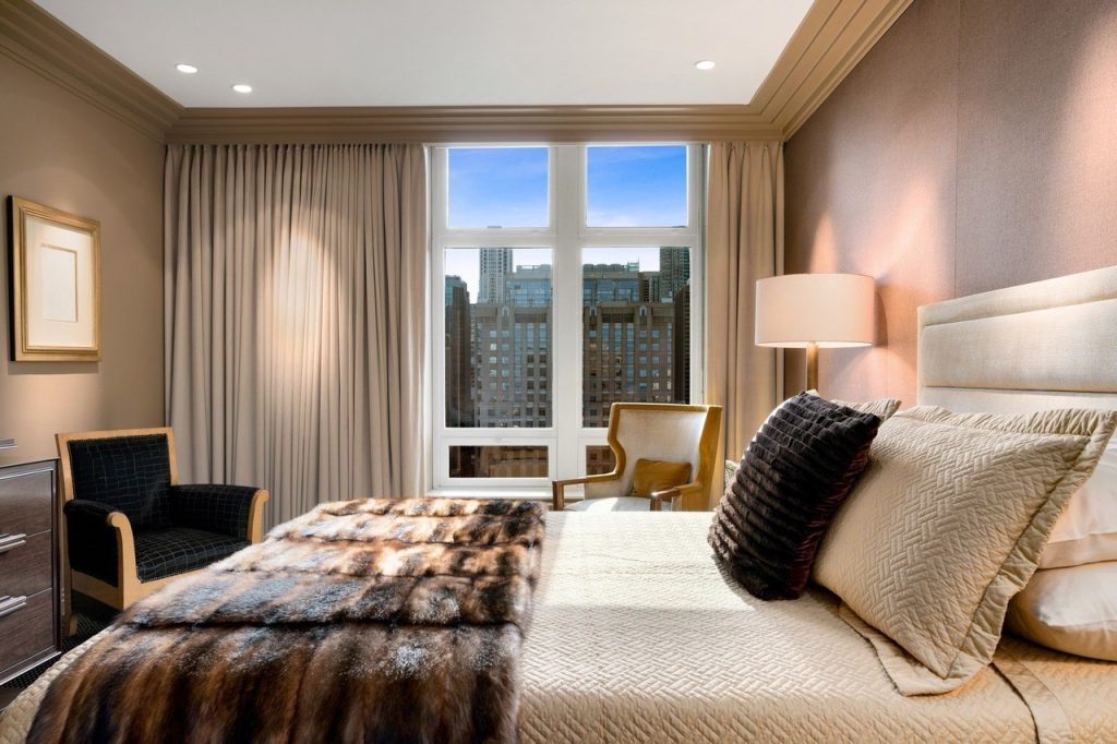 bedroom with view of city