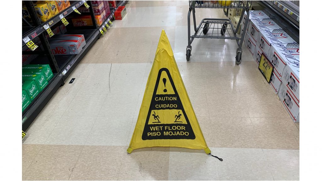 caution sign in a grocery aisle