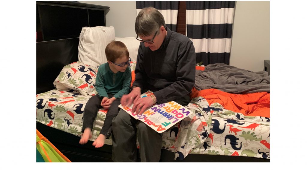 Pete reading a print-braille book to our grandson