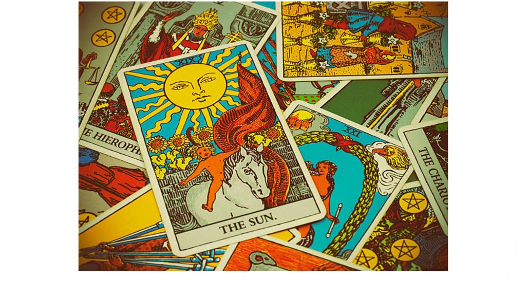 A few Tarot cards with "the sun" on top of the pile