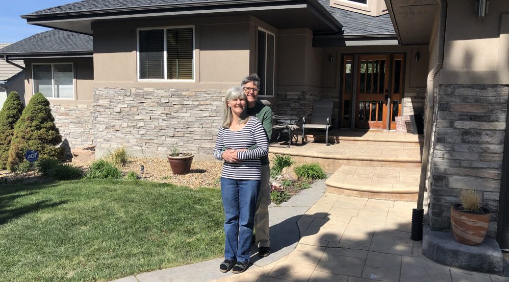 Nancy and Pete in front of their new house