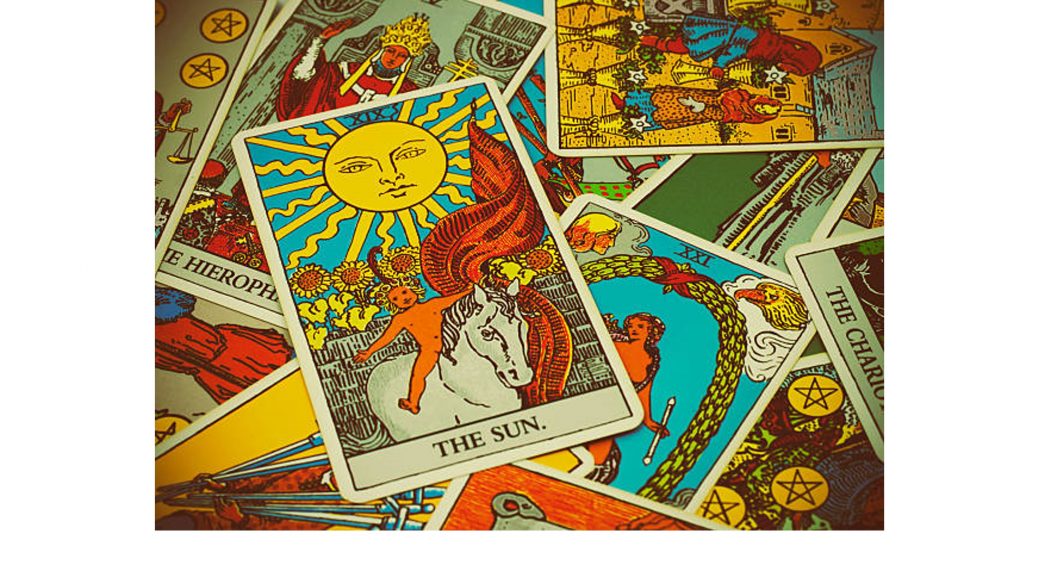 A few Tarot cards with "the sun" on top of the pile
